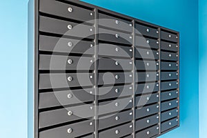 Many post boxes in modern apartment building. Postage boxes in an apartment complex