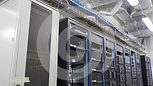 Many powerful servers running in the data center server room. Many servers in a data center. Many racks with servers