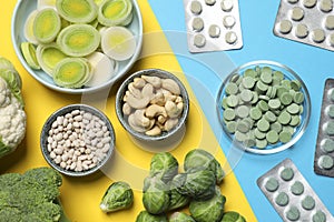 Many prebiotic pills and food on color background , flat lay