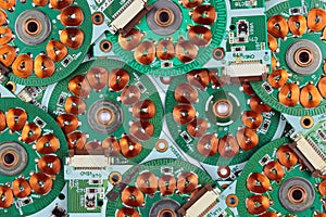 Many printed circuit boards from old floppy drives with windings and coils