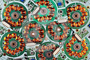 Many printed circuit boards from old floppy drives with windings and coils