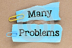 MANY problems words on blue sheets of paper