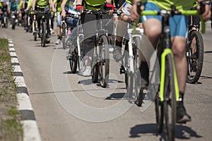 Many racing bikes. A group of cyclists riding during the street