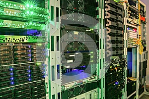 Many racks with servers located in the server room. Bright display a plurality of operating equipment photo