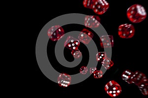 Many red dice flying on black background. Gambling concept