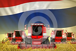 Many red farming combine harvesters on wheat field with Thailand flag background - front view, stop starving concept - industrial