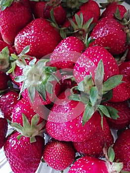 Many red fresh strawberries on the table