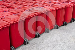 Many red hazardous waste bins with rubbish from COVID-19 patients behind the field hospital between waiting to be disposal photo