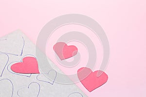 Many red paper hearts on pink background. Valentine day handmade scrapbooking