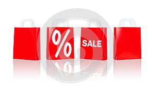 Many red shopping bags with sale and percentage