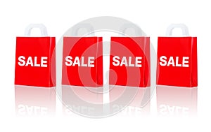 Many red shopping bags with sale word