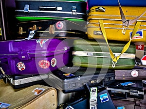 Many of retro vintage old baggages and luggages stacked together photo