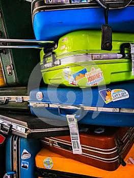 Many of retro vintage old baggages and luggages stacked together photo