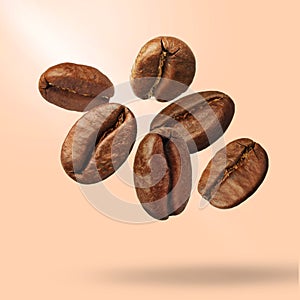 Many roasted coffee beans falling on beige background