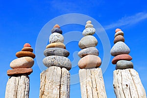 Many of the Rock zen pyramid of white and pink pebbles on a background of blue sky