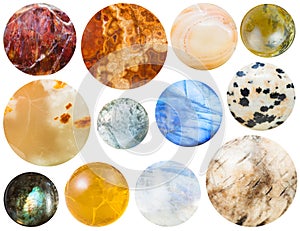 Many round cabochon gem stones isolated on white