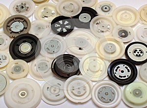 Many round plastic clamps from cd and dvd disc drives