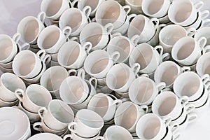 Many rows of white ceramic coffee or tea cups