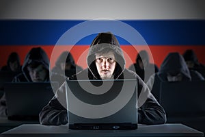 Many russian hackers in troll farm. Cyber crime and security concept. Russia flag in background.