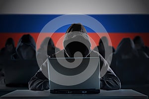 Many russian hackers in troll farm. Cyber crime and security concept. Russia flag in background.