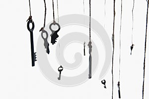 Many rustic keys hanging on string. Selective focus. Isolated