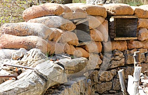 many Sandbags of a trench dug in the ground to defend army soldiers from enemy raids photo