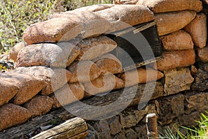 many Sandbags of a trench dug in the ground to defend army soldiers from enemy raids photo