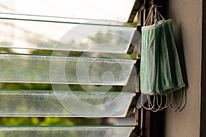 Many sanitary masks hanging on the louver window frames