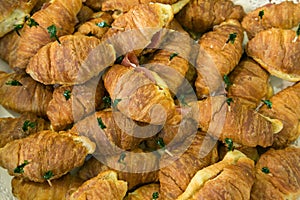 Many savory croissants stuffed with salami