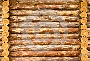Many sawed pine logs stacked in a wall
