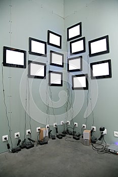 Many screens on wall