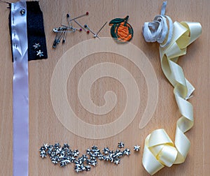 Many seamstress elements on a clear wooden background