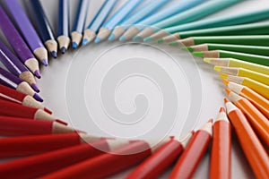 Many sharp multicolored sharp pencils lying in shape of circle closeup background