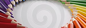 Many sharp multicolored sharp pencils lying in shape of circle closeup background