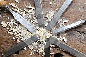 many sharp steel blades many chisels and sawdust chippings in Wo