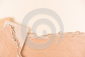 Many sheets of corrugated cardboard over light brown background as eco background with copy space