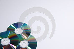 Many shiny compact discs on light background. Space for text
