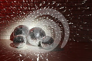 Many shiny disco balls indoors, color toned. Space for text