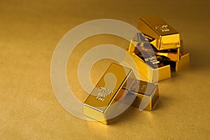 Many shiny gold bars on color background. Space for text