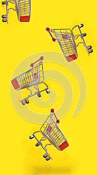 Many shopping carts are flying with yellow background