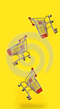 Many shopping carts are flying with yellow background