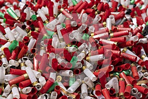 Many shotgun shells of various colors with empty fired cartridges , Can be used as a texture background