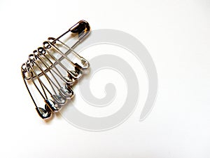 many size of safety pin on white background