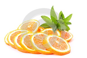 Many sliced oranges and green plant