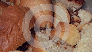 Many slices of stale bread. Dry bread thrown in the trash. Discarded moldy stale bread close up. Food loss and waste