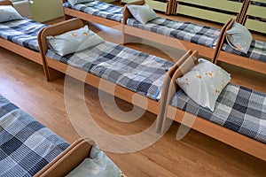 Many small beds in daycare preeschool empty bedroom