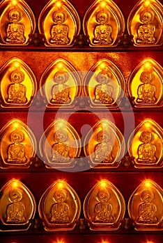 Many small golden God shaped coins decorated with pillars in Chinese shrines in Thailand.