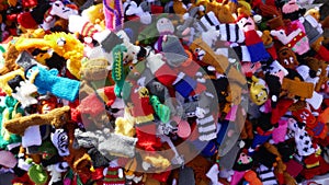 Many small self-made colorful finger puppets for sale at a flea market
