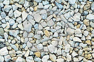 Many small stones of different colors, gravel or crushed stone close-up texture