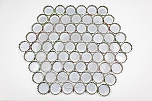 Many soda water bottle caps placed on a white background